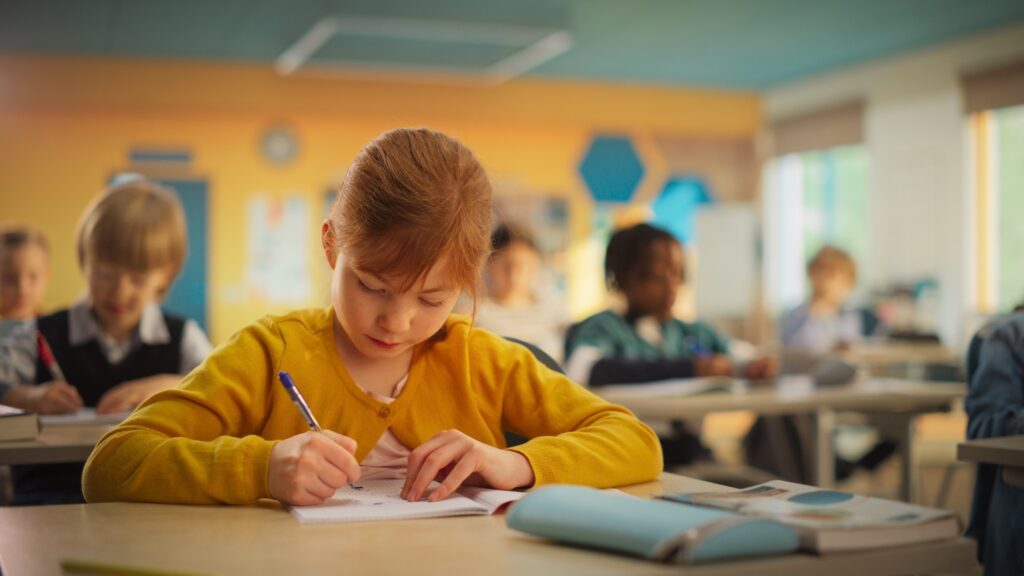 Primary School Children Working on a Test Assignment in Class: Smart Diverse Kids Focused on Exercises, Thinking, Searching for a Correct Solution. Schoolchildren Getting Modern Education