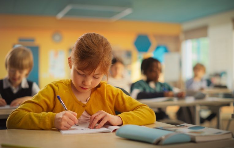 Primary School Children Working on a Test Assignment in Class: Smart Diverse Kids Focused on Exercises, Thinking, Searching for a Correct Solution. Schoolchildren Getting Modern Education