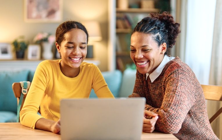 Mother,And,Daughter,Doing,Homework,With,Laptop,At,Home.,Mom